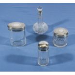 Three silver topped jars and a scent bottle with silver collar