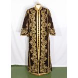 A lady's brown velvet and gold Arabic kaftan dress