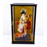 A cased egg shell porcelain figure of a Japanese geisha