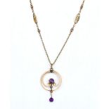 A 9ct gold pendant set with two amethysts and two seed pearls, with 9ct gold detailed chain length