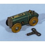 A small tin plate play worn racing car with key in working order. 8cm