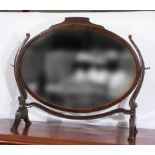 An Edwardian mahogany oval toilet mirror