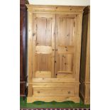 A modern pine two door wardrobe