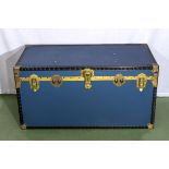 A large blue vintage steamer trunk