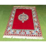 A decorative red ground rug 208cm x 148cm