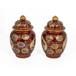 A pair of Chinese red and gold glazed ginger jars, 25cm tall