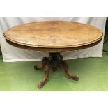 A Victorian walnut breakfast table in need of restoration