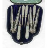 A cased set of lobster claw crackers and picks with MOP handles, one pick missing