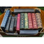 A box of leather bound books and Bibles