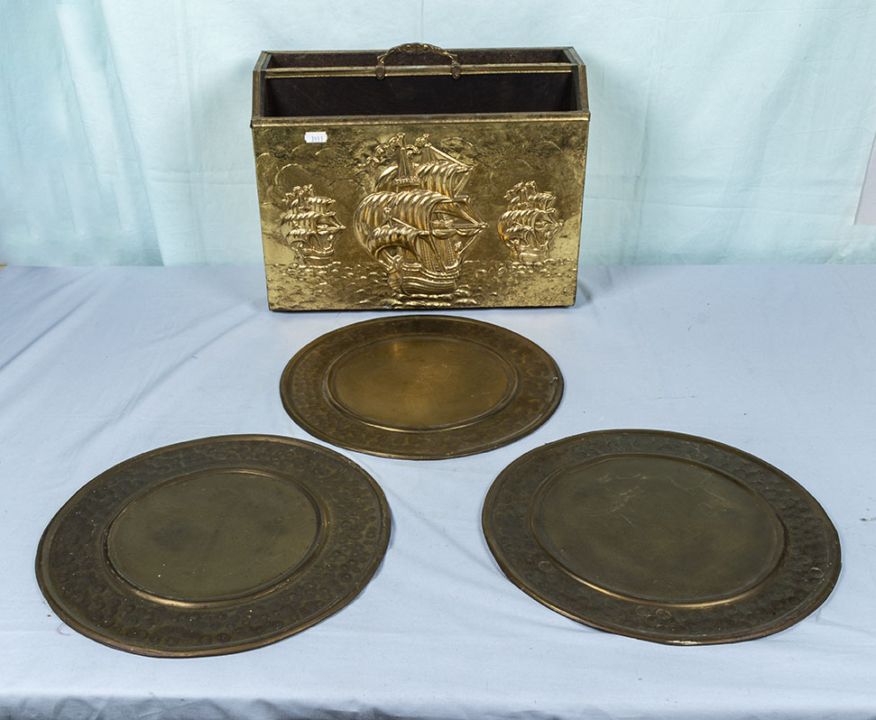 Three brass plaques and a magazine rack