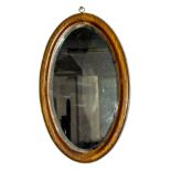A mahogany framed oval wall mirror