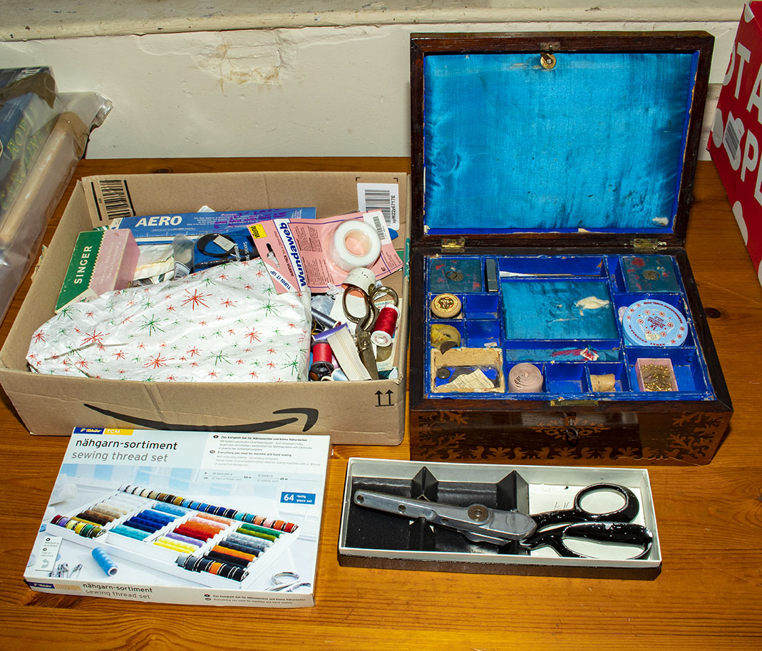A sewing box together with a quantity of sewing accessories