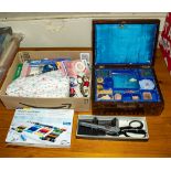 A sewing box together with a quantity of sewing accessories