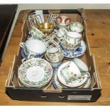 A box containing porcelain cups and saucers (trios)