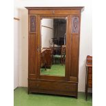 An Edwardian single mirrored door mahogany wardrobe