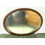 A mahogany framed oval wall mirror