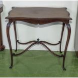 A mahogany side table with shaped top and stretcher