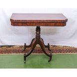 Mahogany Regency tea table supported on turned column and sabre legs terminating on large brass