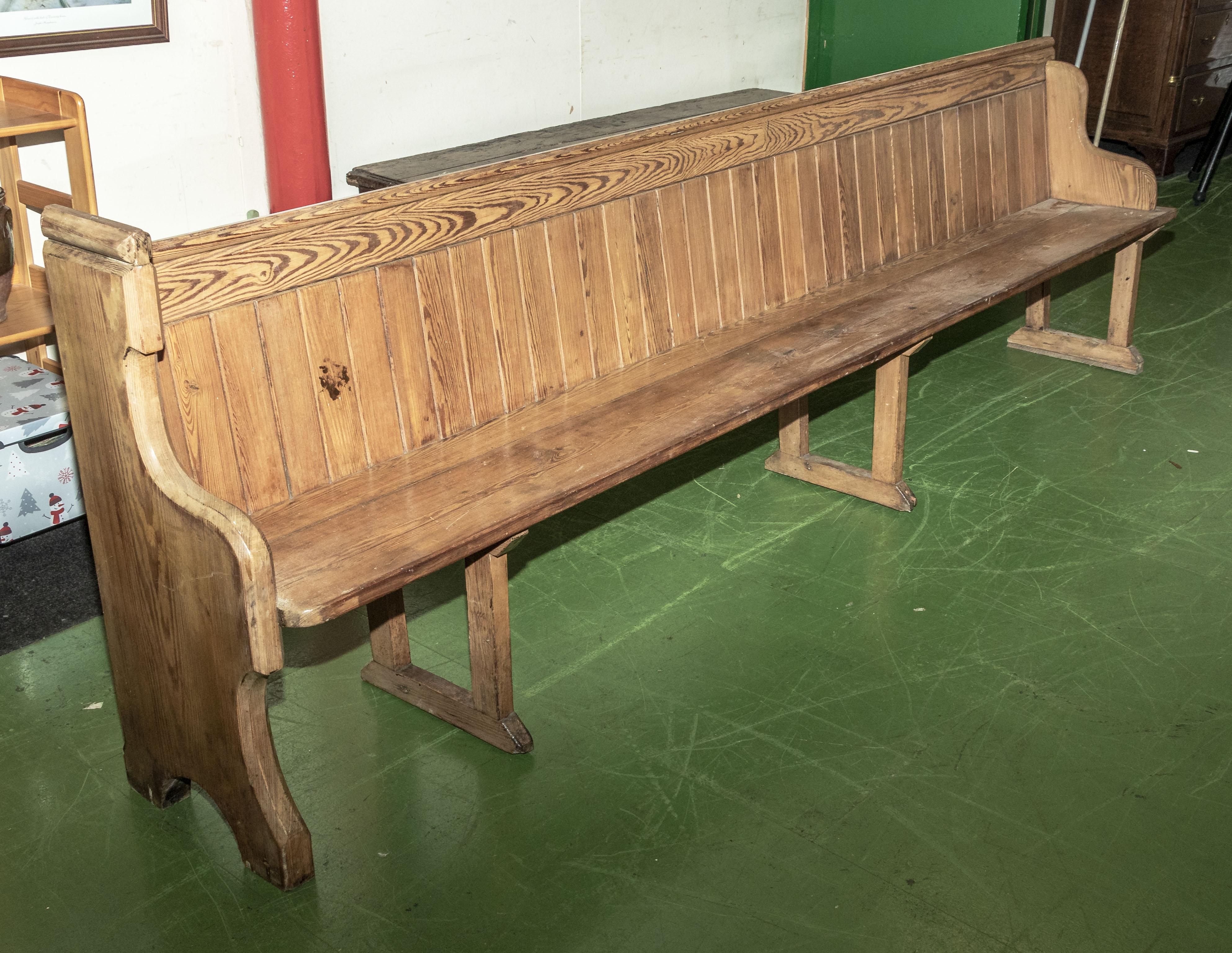 An antique pitch pine church pew 9.5 feet long