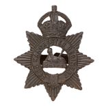 Manchester Regiment OSD field service cap badge. Good scarce die-cast crowned star bearing tile