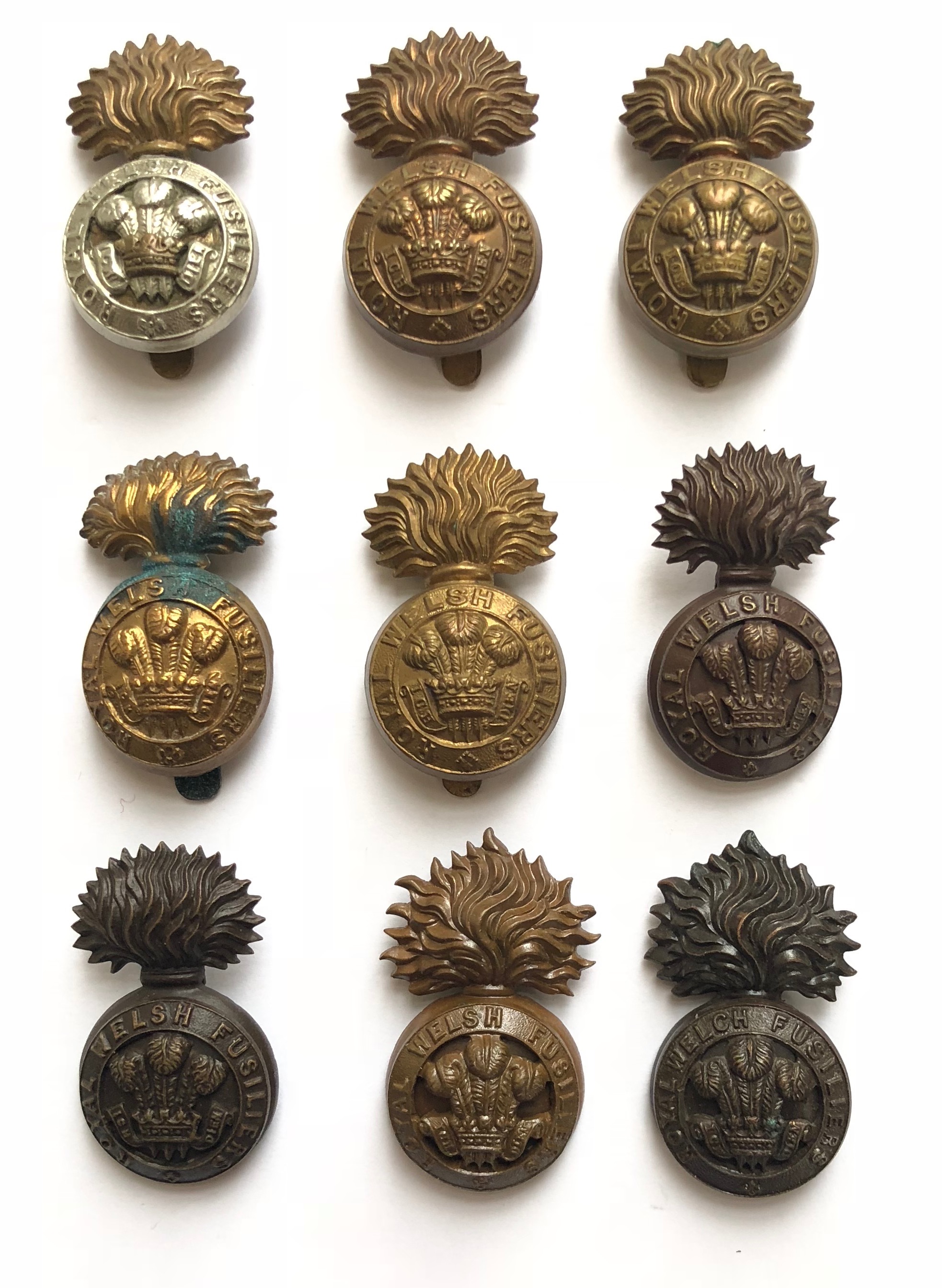 9 Royal Welsh / Welch Fusilier cap badges. Bi-metal R Welsh F on slider ... 4 x 1916 brass economy