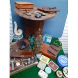 A carved Eastern table with folding stand, a display case A/F, vintage tobacco and other tins,