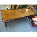 An early 20th century mahogany side table having lyre ends, central turned support and on brass claw