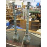 A pair of green painted wooden candlesticks A/F Location: LAF