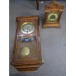 The Ansonia Clock Co wooden cased 8-day mantel clock, the movement striking on a gong, and a