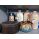 A Royal Doulton tobacco jar and a milk jug A/F together with three Doulton foot warmers and a late