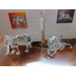 Swarovski SCS collectables - a crystal model of a lion and a model of an elephant, both in