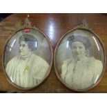 Two early 20th century portraits of ladies with convex glass in metal frames and a wooden till