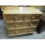 An early 20th century pine chest of four drawers, on turned feet 82cm h x 85cm w