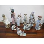 Nine Lladro figures and animals to include a Japanese girl, a fisherman, dogs, cats and others