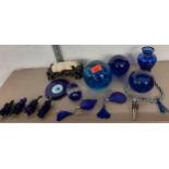 A collection of decorative ornaments to include glass paperweights and blue overlaid vase