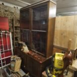 A late 19th/early 20th century mahogany bookcase having two glazed doors above two cupboard doors