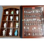 Collectors spoons cased, and miniature porcelain vases, all housed in two treen wall shelves