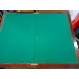 An early 20th century mahogany card table with folding top having a green felt inset above