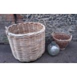 An oversized log basket A/F, a smaller basket, a terrarium bottle and a vintage telephone table