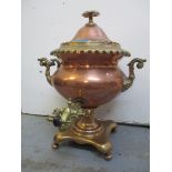 A Victorian brass and copper samovar with turned handles Location: