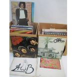 Two boxes of albums and records to include Pink Floyd, Eric Clapton, Michael Jackson, The Beatles