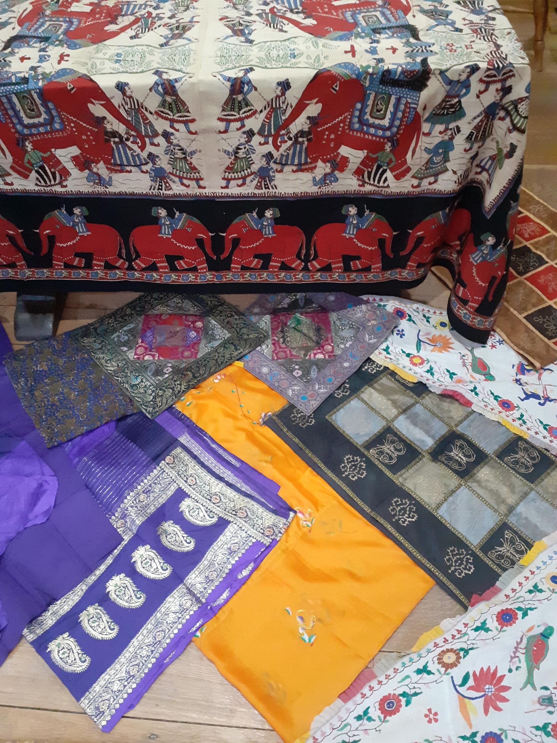 A quantity of 20th Century Eastern textiles to include an Indian cotton tablecloth depicting printed