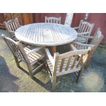 A Barlow Tyrie teak garden table, 69.5cm h x 149cm w and six matching chairs together with a Parasol