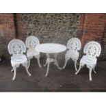 A white painted metal garden table and four chairs