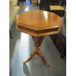 A Victorian walnut trumpet-shaped sewing table/work box having an octagonal hinged top and on