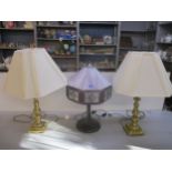 A patinated brass table lamp with Tiffany style shade, along with two brass table lamps with