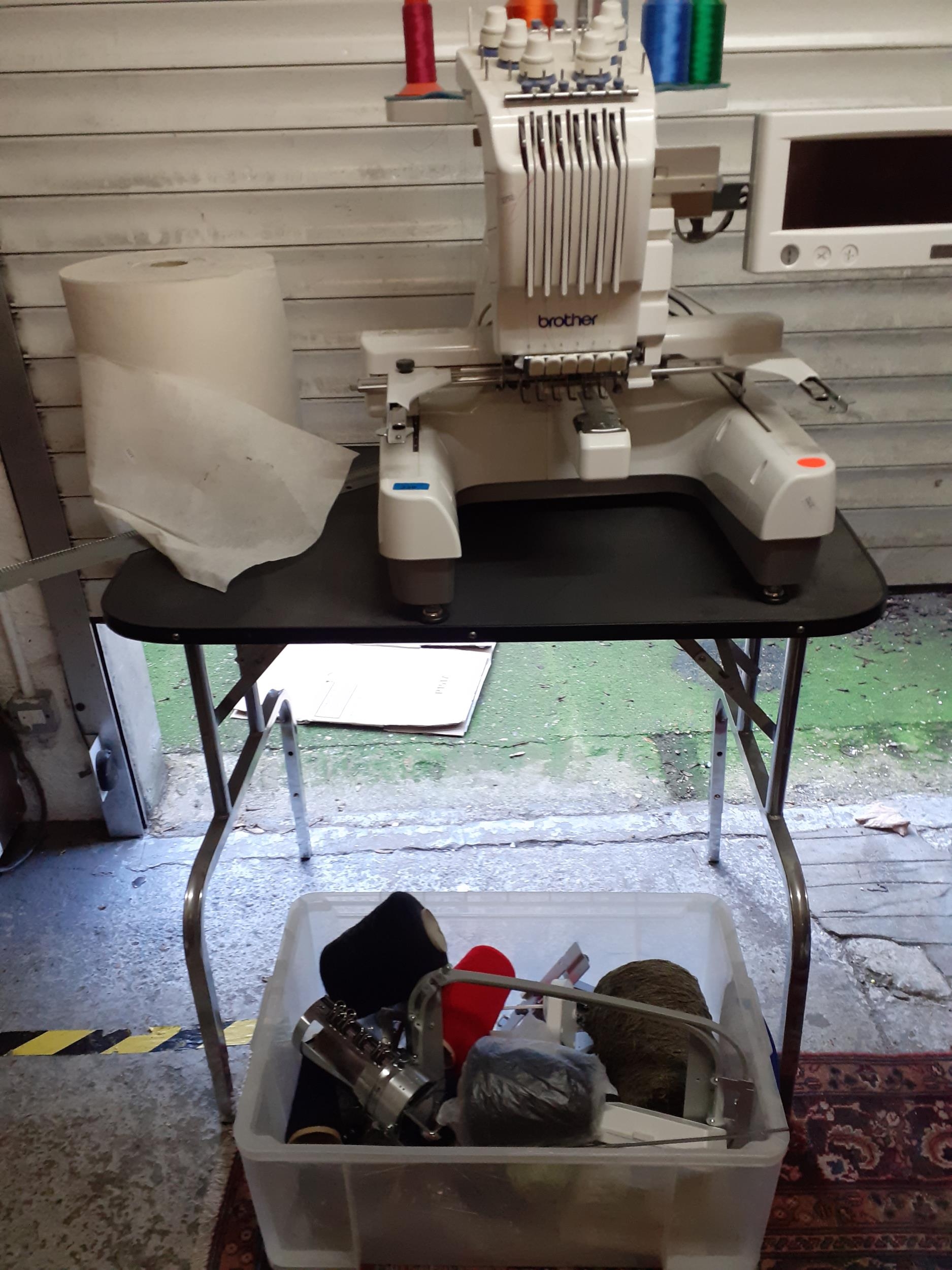 A Brother PR-620 professional embroidery machine with accessories, reels and a table (originally