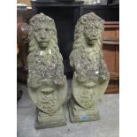 A pair of garden composition ornaments of lions leaning on shields, 82cm h x 25cm w Location: