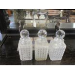 A Betjemann's silver plated three bottle tantalus with three cut glass decanters and stoppers, (no