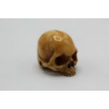 An 18th/19th century Japanese ivory netsuke of a skull by Shosai, signed, 2.7cm high
